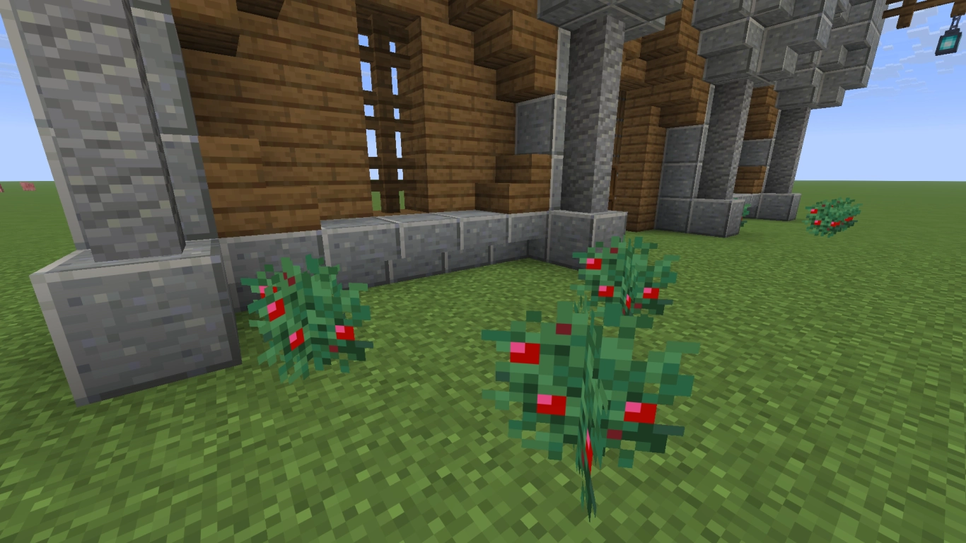Trappole e blocchi dannosi davanti a un muro di Minecraft, tra cui blocchi di magma e cespugli di bacche